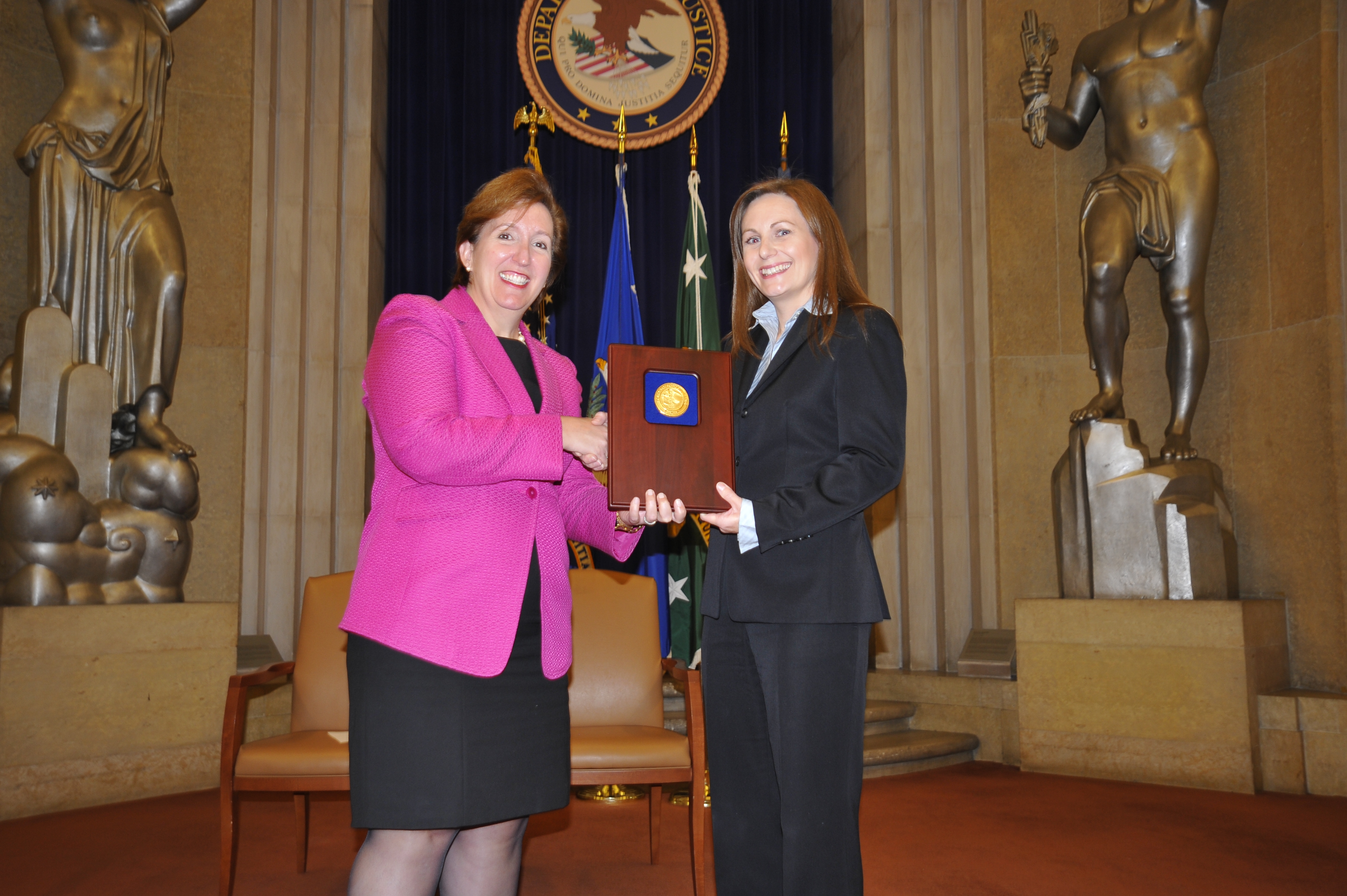 Acting Assistant Attorney General Sharis Pozen presents a 2011 Assistant Attorney General Award to Christine Hill.