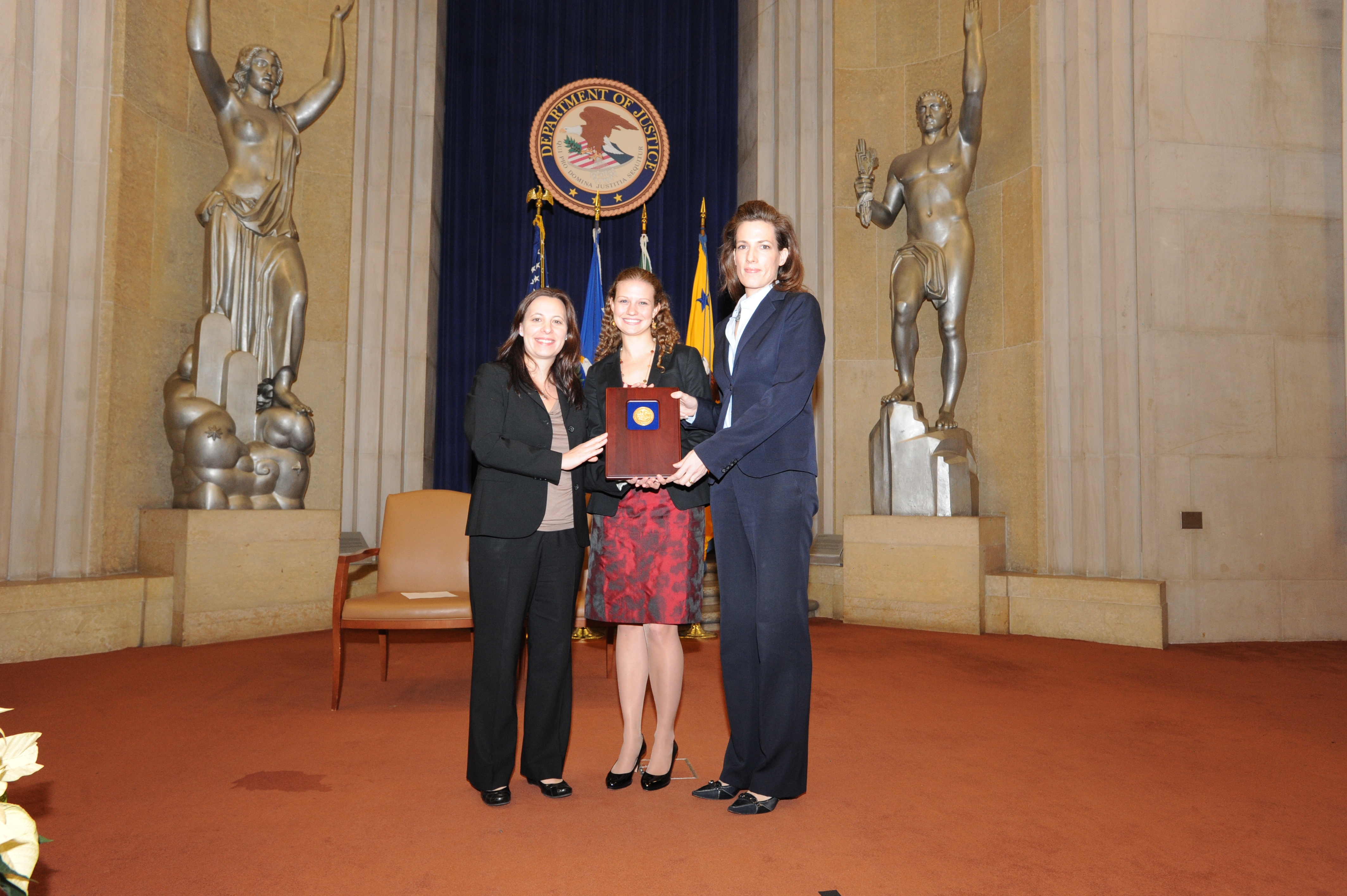 Helen Christodoulou, Caitlin Morrison, and Elizabeth Prewitt accept a 2011 Assistant Attorney General Team Award