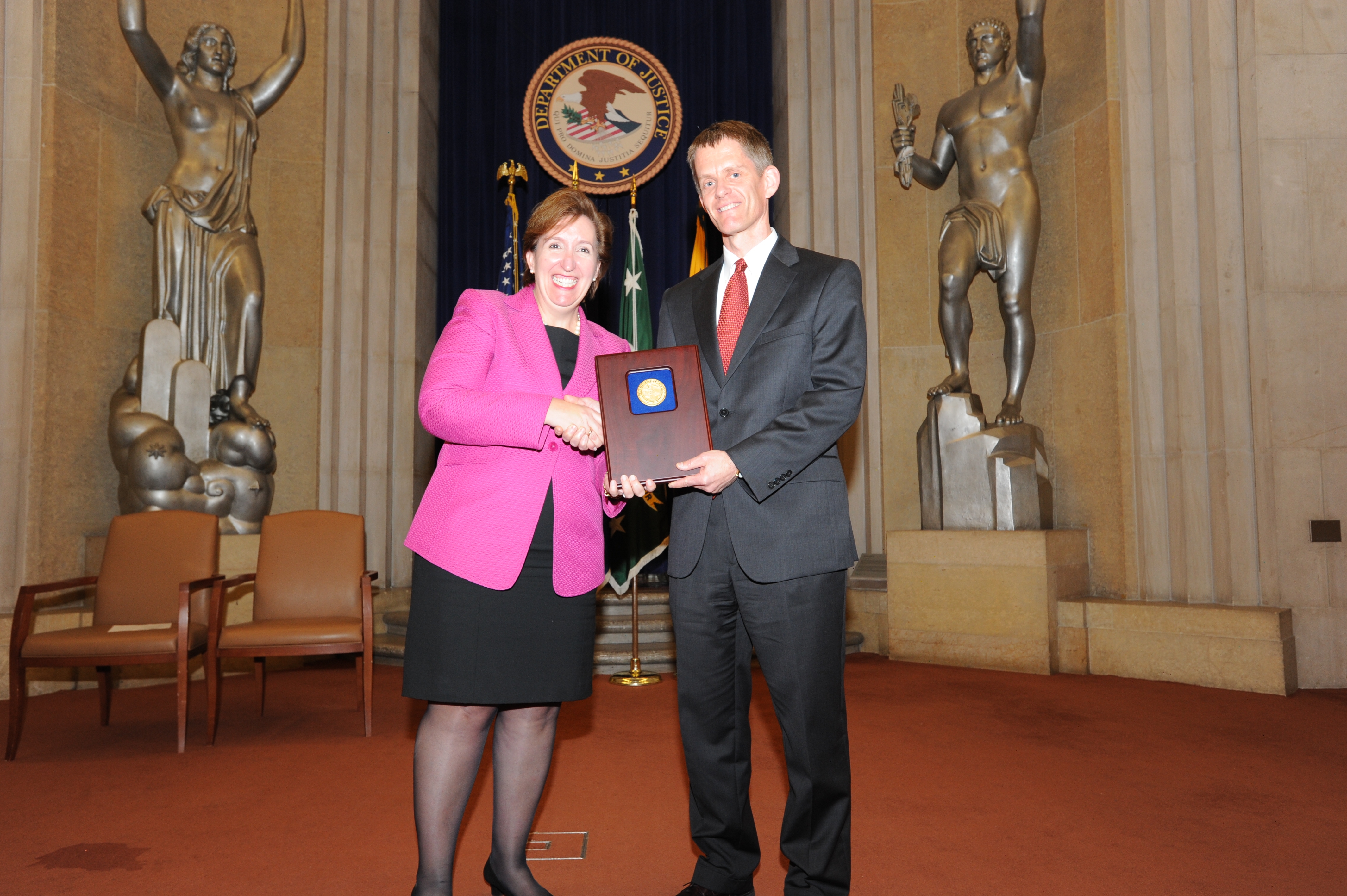 Acting Assistant Attorney General Sharis Pozen presents the 2011 Morrison Award to Jon Jacobs.