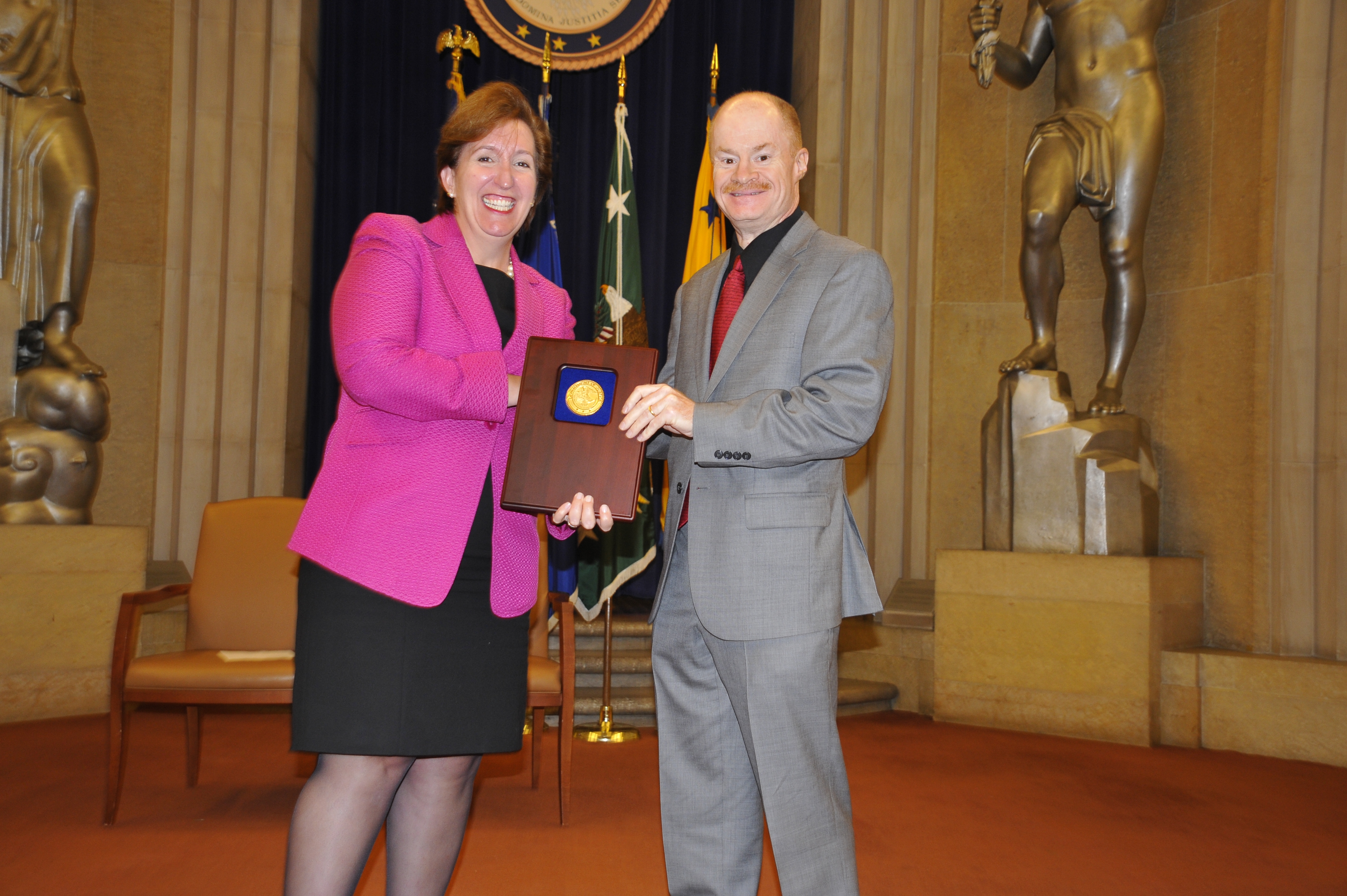 Acting Assistant Attorney General Sharis Pozen presents a 2011 Assistant Attorney General Award to Wayne Dunham.