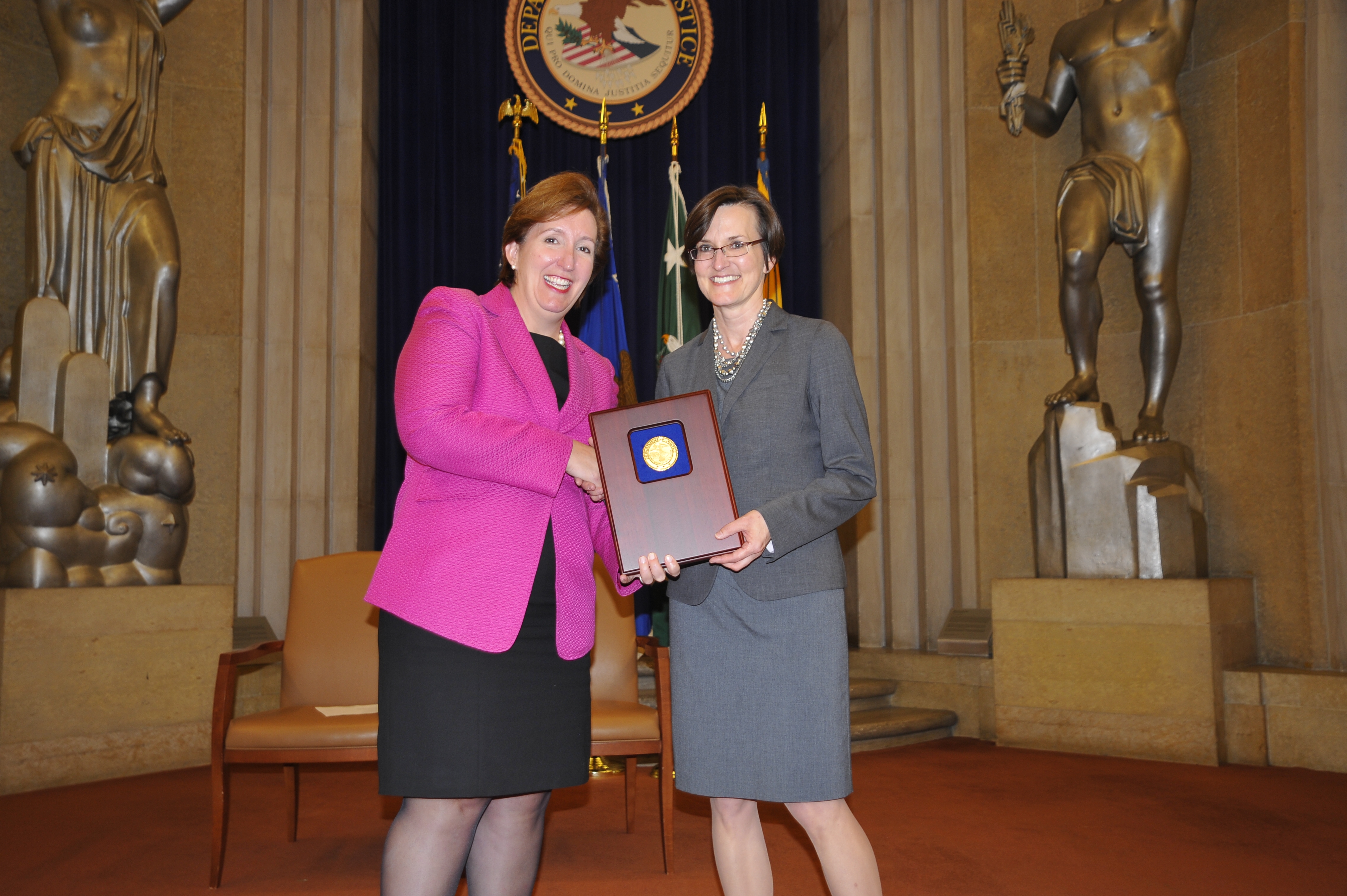 Acting Assistant Attorney General Sharis Pozen presents a 2011 Assistant Attorney General Award to Yvette Tarlov.