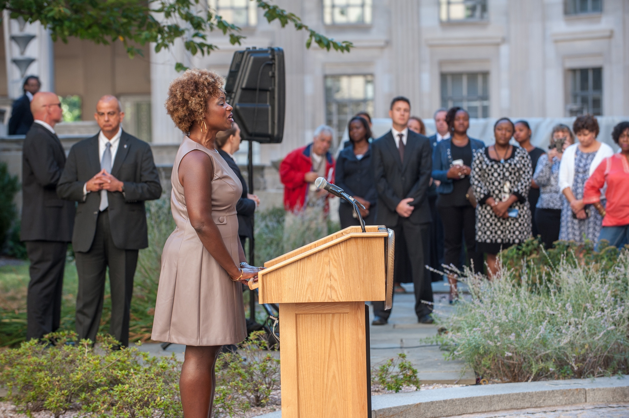 Rhea Walker, Special Assistant, Office of Justice Programs, sings God Bless America during the commemoration ceremony of the 14t