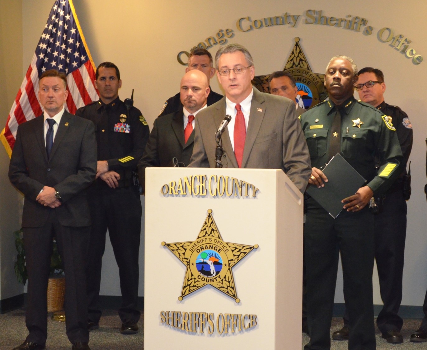 Acting US Attorney Muldrow briefs media.