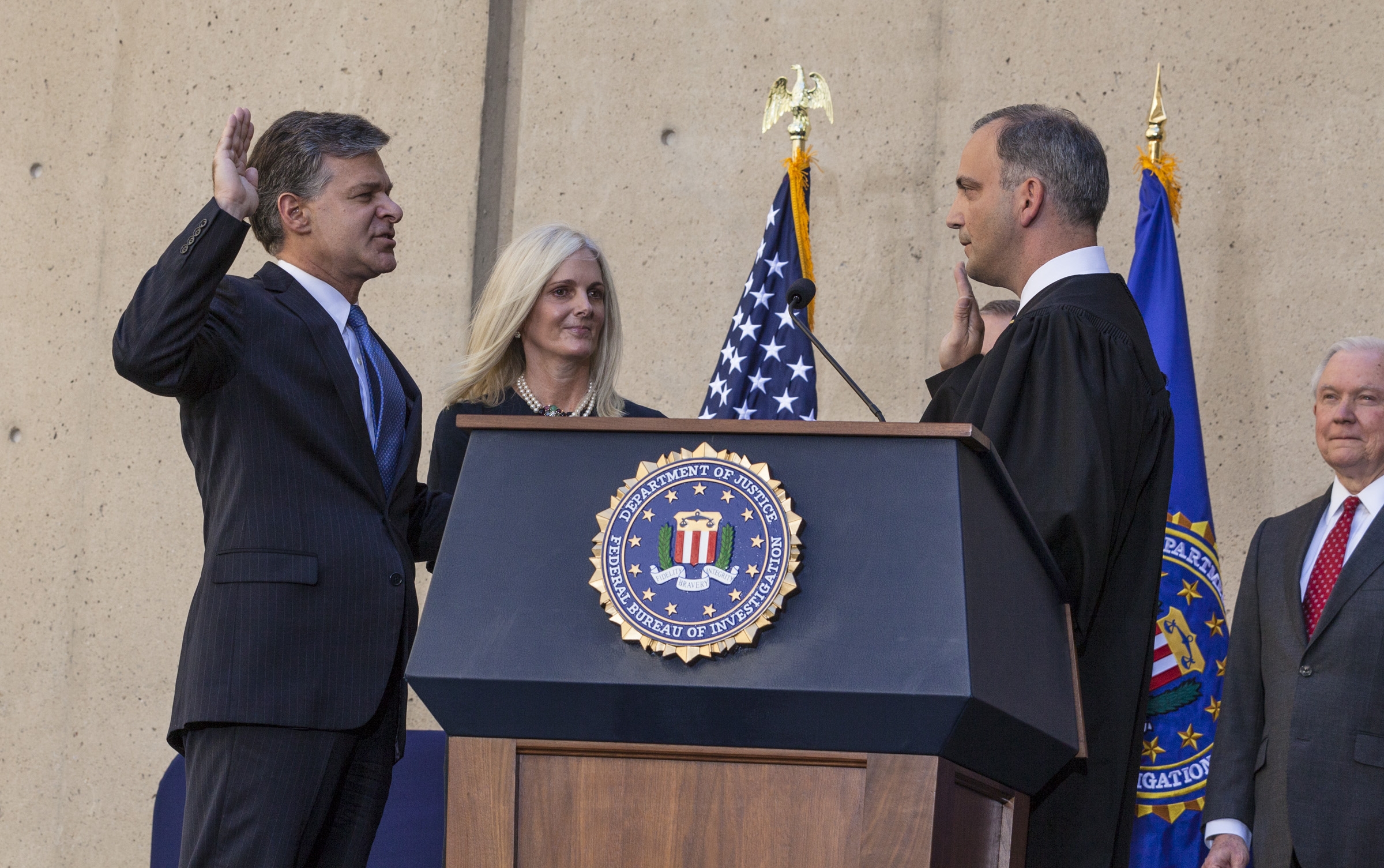 FBI Director Chris Wray, accompanied by his wife Helen Wray, FBI Deputy Director Andrew McCabe and Attorney General Jeff Sessions, is administered the ceremonial oath of office by U.S. District Court Judge Joseph Bianco.