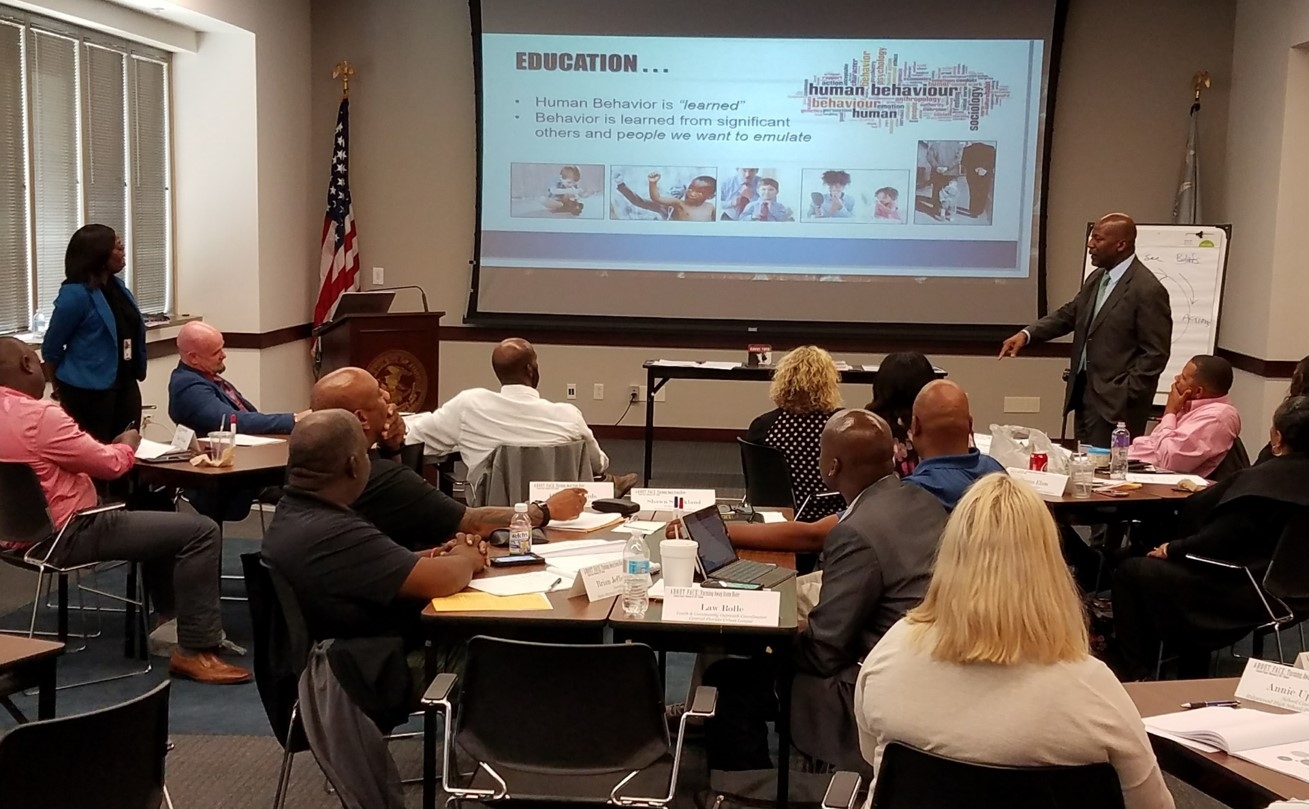 USAO Community Outreach Specialists discuss Adult/Youth learning systems.