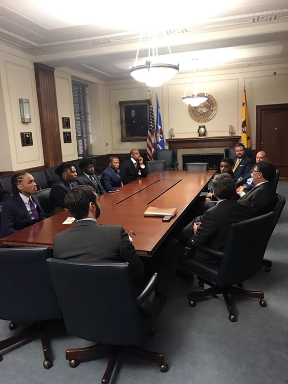 High school students from Communities in Schools of Atlanta with Assistant Attorney General Makan Delrahim, along with Principal Deputy Assistant Attorney General Andrew Finch and Chief of Staff John Elias sitting at the AAG’s conference table.
