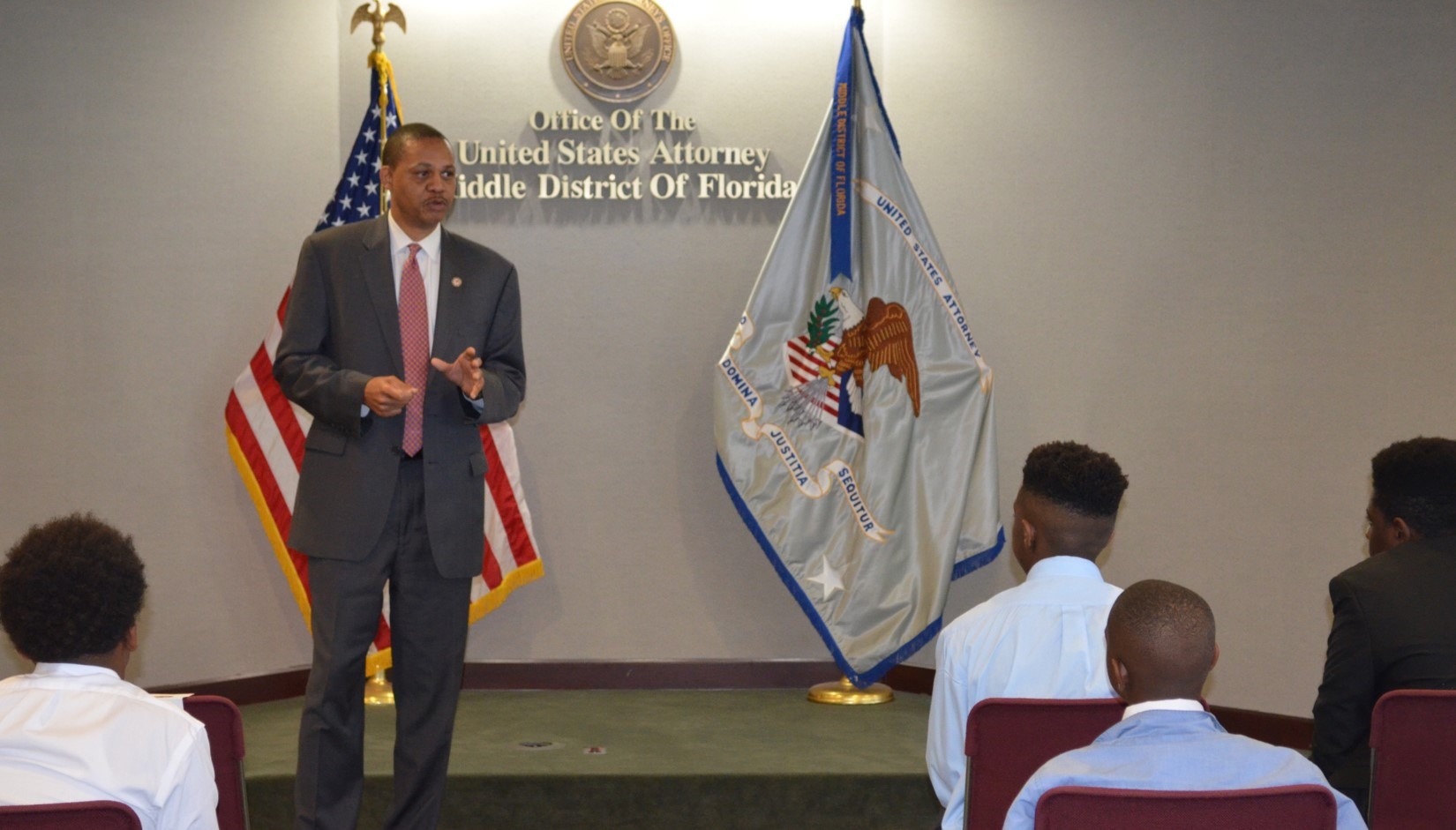 Public Affairs Officer William Daniels congratulates the students.