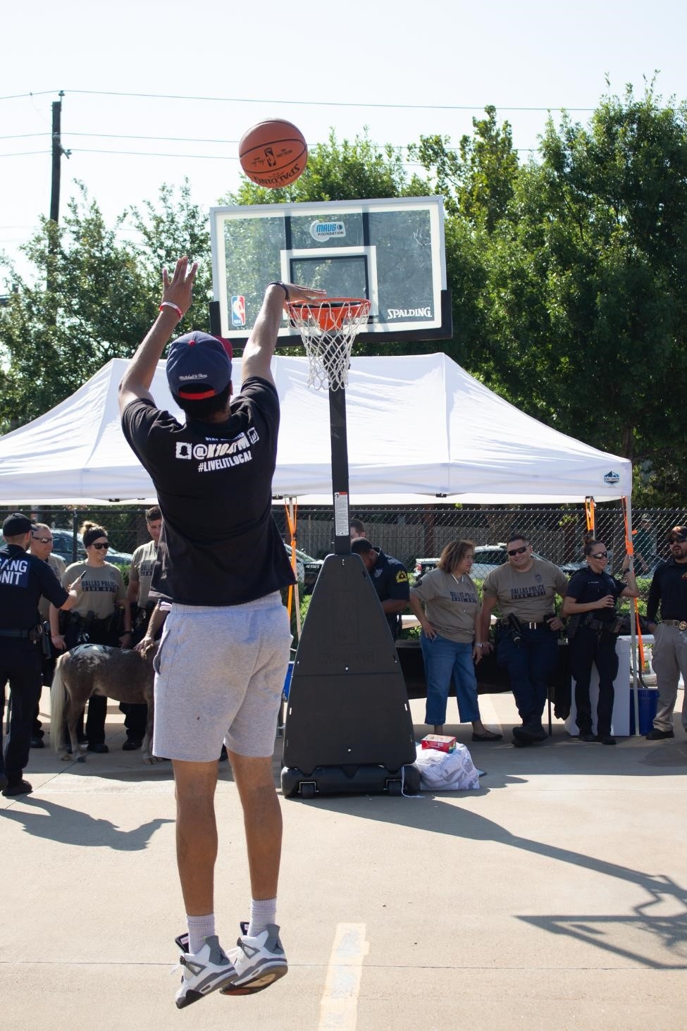 Federal and State Law Enforcement interact with the community while competing in a 3-point contest.