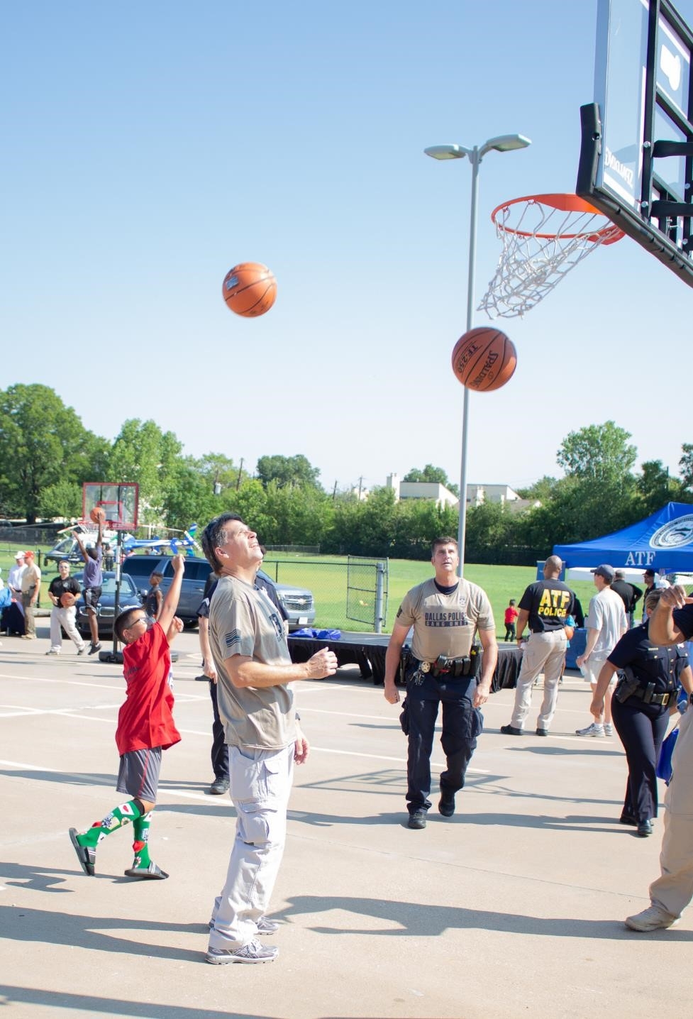 Federal and State Law Enforcement interact with the community while competing in a 3-point contest.