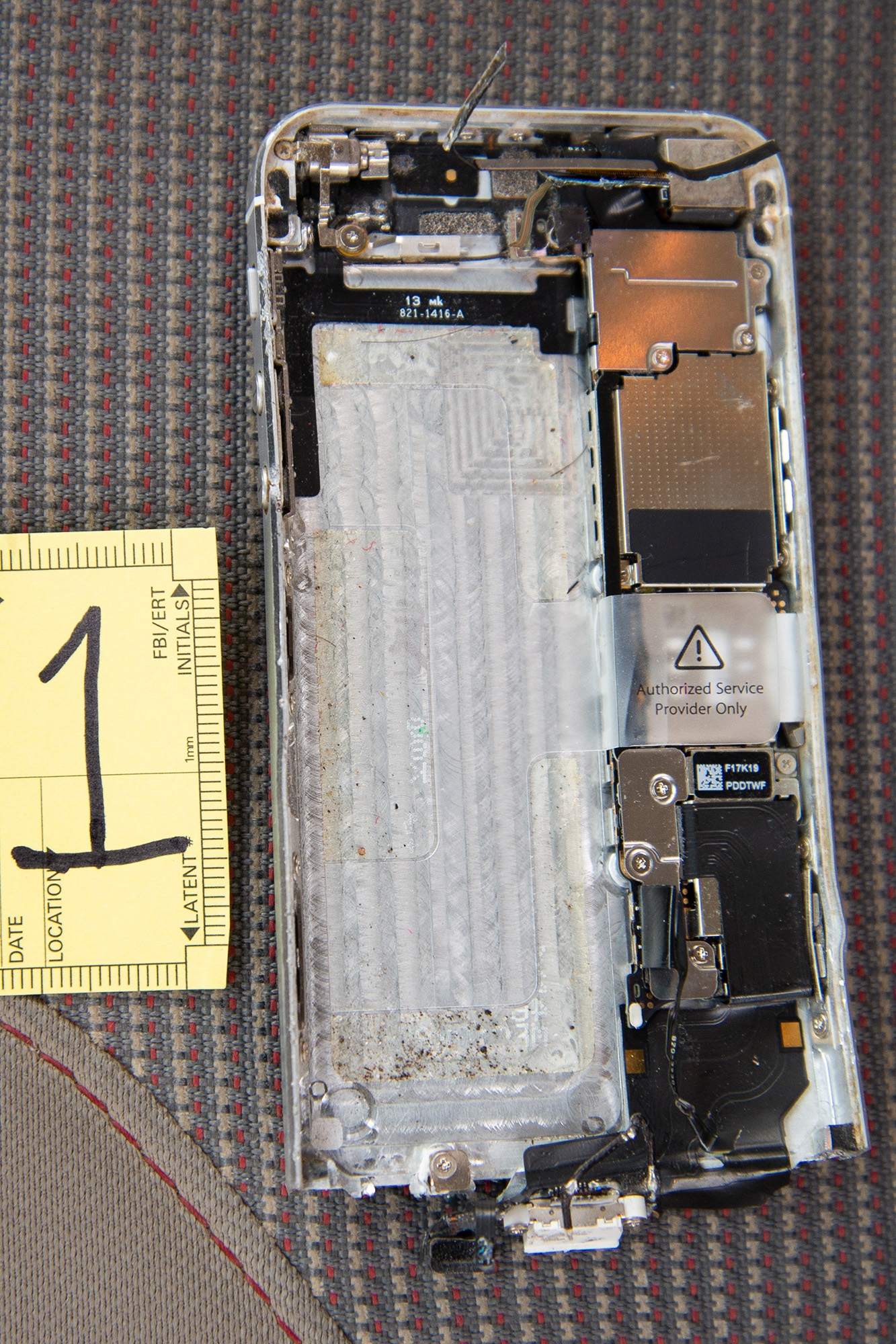 Evidence photo of a shattered iPhone.