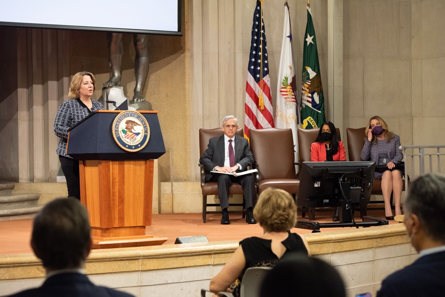 Deputy Attorney General Lisa O. Monaco speaks at a podium with the Department of Justice seal.