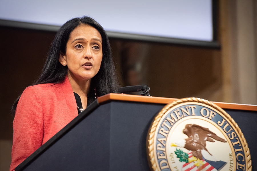 Associate Attorney General Vanita Gupta speaks at a podium with the Department of Justice seal.
