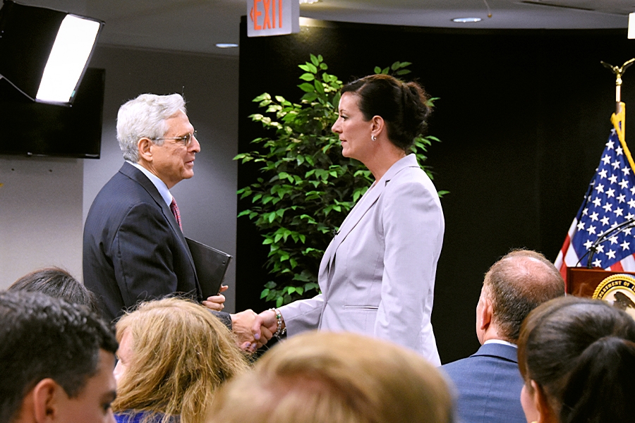 The newly appointed Director of the Federal Bureau of Prisons Colette S. Peters shakes hands with the Attorney General.