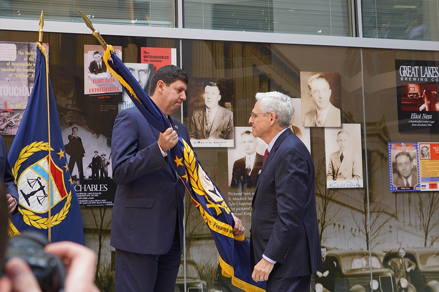 Attorney General Merrick B. Garland hands over the ATF flag to its new Director Steve Dettelbach.