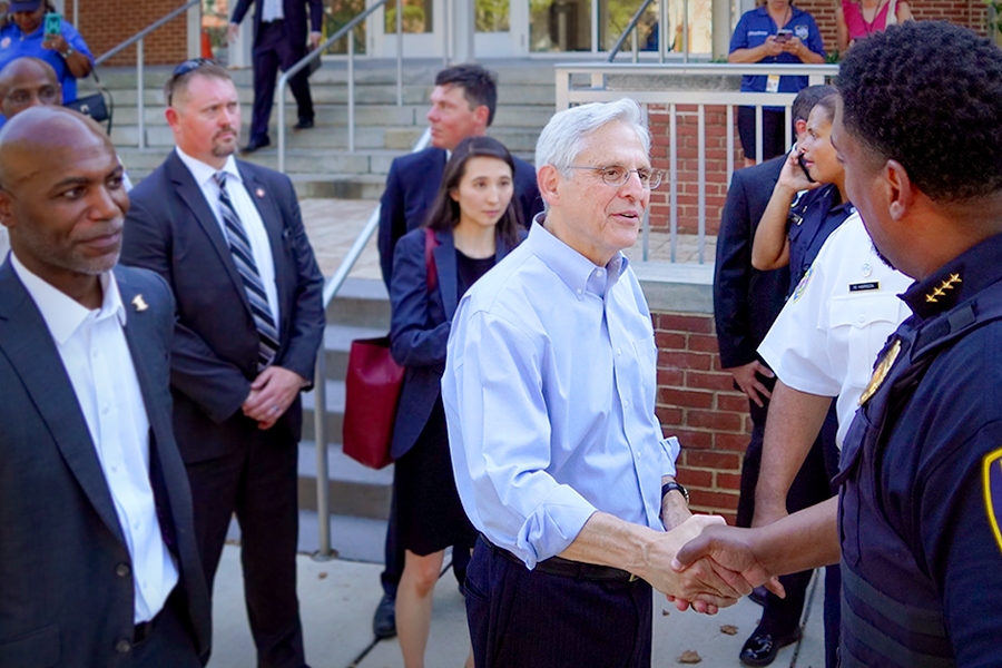 Attorney General Merrick B. Garland shakes hands with law enforcement officers on National Night Out in Baltimore, M.D.