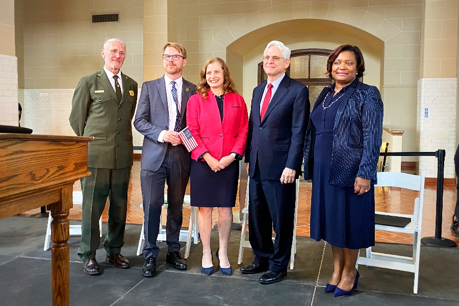 The Attorney General stands with officials for a group photo.