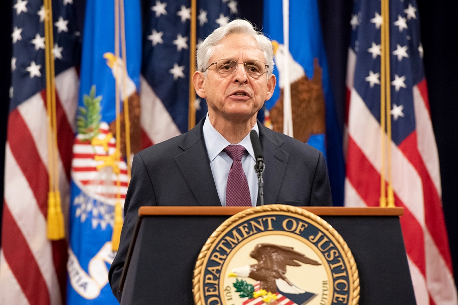 Attorney General Merrick Garland addresses the audience at the Department of Justice from a podium bearing the Department of Justice seal