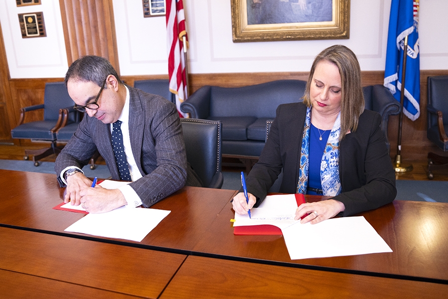 Assistant Attorney General Jonathan Kanter of the Justice Department’s Antitrust Division (left) and Inspector General Christi Grimm (right) sign a memorandum of understanding (MOU) to protect health care markets.