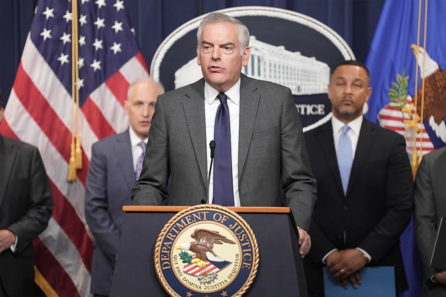Matthew S. Axelrod, Assistant Secretary for Export Enforcement at the Department of Commerce delivers remarks from a podium bearing the Department of Justice seal