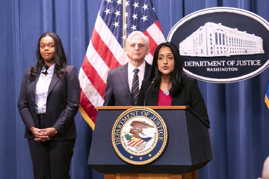 Associate Attorney General Vanita Gupta delivers remarks from a podium bearing the Department of Justice seal.