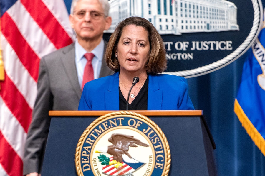 Deputy Attorney General Lisa O. Monaco delivers remarks from a podium bearing the Department of Justice Seal.