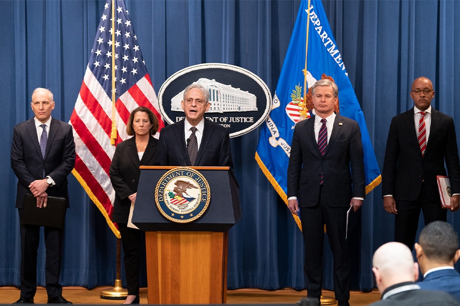 Attorney General Merrick B. Garland delivers remarks from a podium bearing the Department of Justice seal.