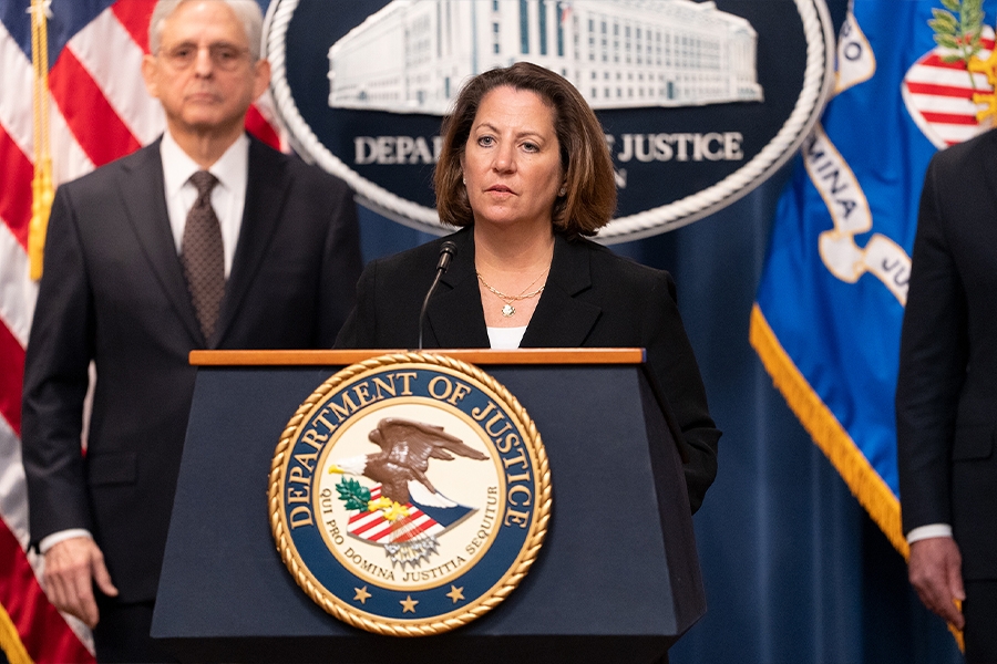 Deputy Attorney General Lisa O. Monaco delivers remarks from a podium bearing the Department of Justice seal.