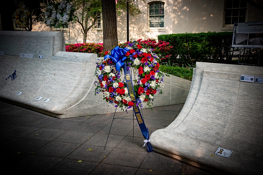 A wreath rests on a stand at the National Law Enforcement Memorial with a ribbon that reads, “Law Enforcement Fallen Heroes.”
