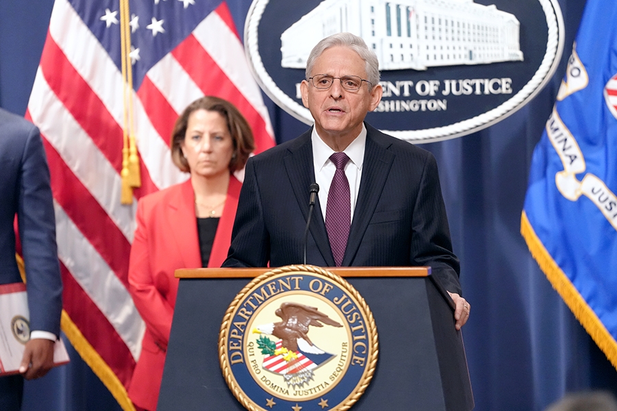 Attorney General Merrick B. Garland delivers remarks from a podium bearing the Department of Justice seal.