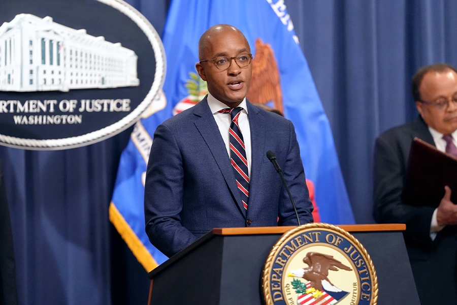 U.S. Attorney for the Southern District of New York Damian Williams delivers remarks from a podium bearing the Department of Justice seal.