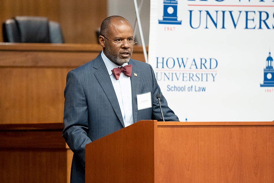 U.S. Attorney for the Northern District of California Ismail Ramsey delivers remarks from a podium at Howard University School of Law.