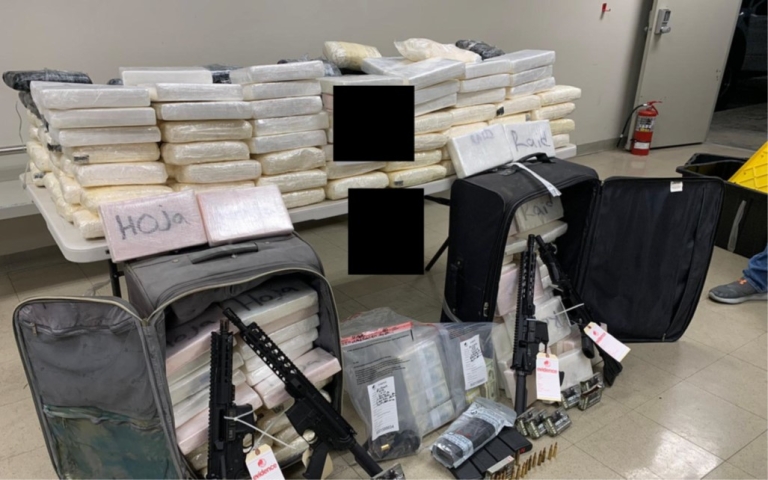 Picture of 338 kilograms of seized cocaine, cash, and four assault rifles