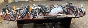 pictures of guns lying on a table 
