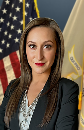 A woman is in front of an American flag