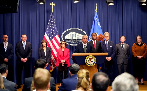 Attorney General Merrick B. Garland delivers at the Department of Justice. He is joined by Department of Justice and federal government officials.