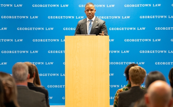Assistant Attorney General Kenneth A. Polite Jr. speaks from a podium to students, staff, and attorneys at Georgetown Law.