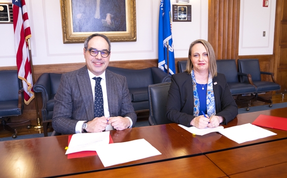 Assistant Attorney General Jonathan Kanter of the Justice Department’s Antitrust Division (left) and Inspector General Christi Grimm (right) sign a memorandum of understanding (MOU) to protect health care markets.