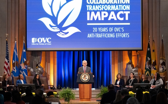 Attorney General Merrick B Garland delivers remarks from a podium in the Great Hall at the Department of Justice.