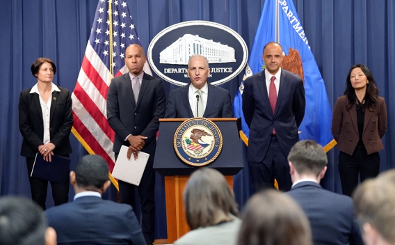 Assistant Attorney General for National Security Matthew G. Olsen delivers remarks from a podium bearing the Department of Justice seal.