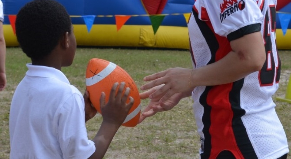 Learning football skills from the ladies of the Tampa Bay Inferno.
