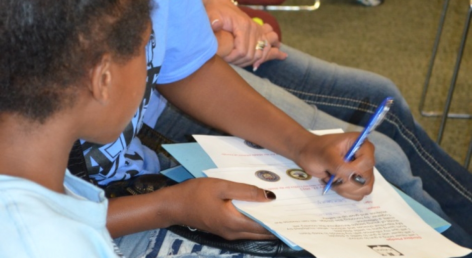Signing the Gun Pledge.