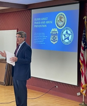 Acting U.S. Attorney Joshua S. Levy speaking at elder fraud seminar
