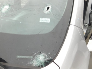 Car windshield with hole and shattered corner