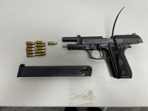 Photo of a firearm with clip and bullets found in Martin’s apartment.  (Government Exhibit 26)  