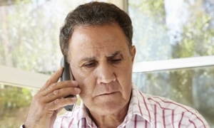 Elder Making a Phone Call for Older Survivors' Resources