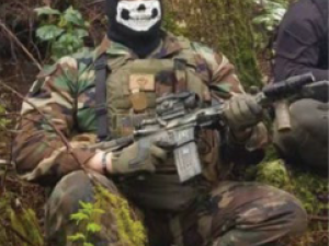 Benton in a mask with firearm