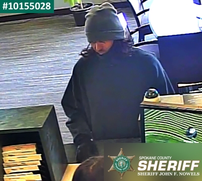 Bank robber wearing a sweatshirt and beanie 