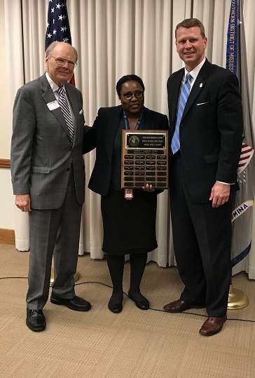 AUSA Angela Williams receives the Robert E. Hauberg Award from Robert Hauberg and U.S. Attorney Mike Hurst