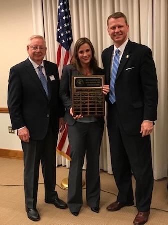 AUSA Kristi Johnson receives the Daniel E. Lynn Award from Daniel E. Lynn and U.S. Attorney Mike Hurst