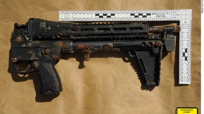 KelTec Sub-2000 9mm folding rifle with dirt on it, and appears to be rusted. White ruler along the gun. Government Exhibit 212, 2:18-cr-00527 cw Photo Credit: FBI